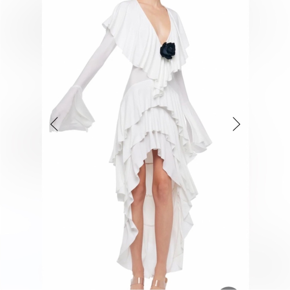 Norma Kamali. Flower not included. It was a designer add on in her campaign ad.